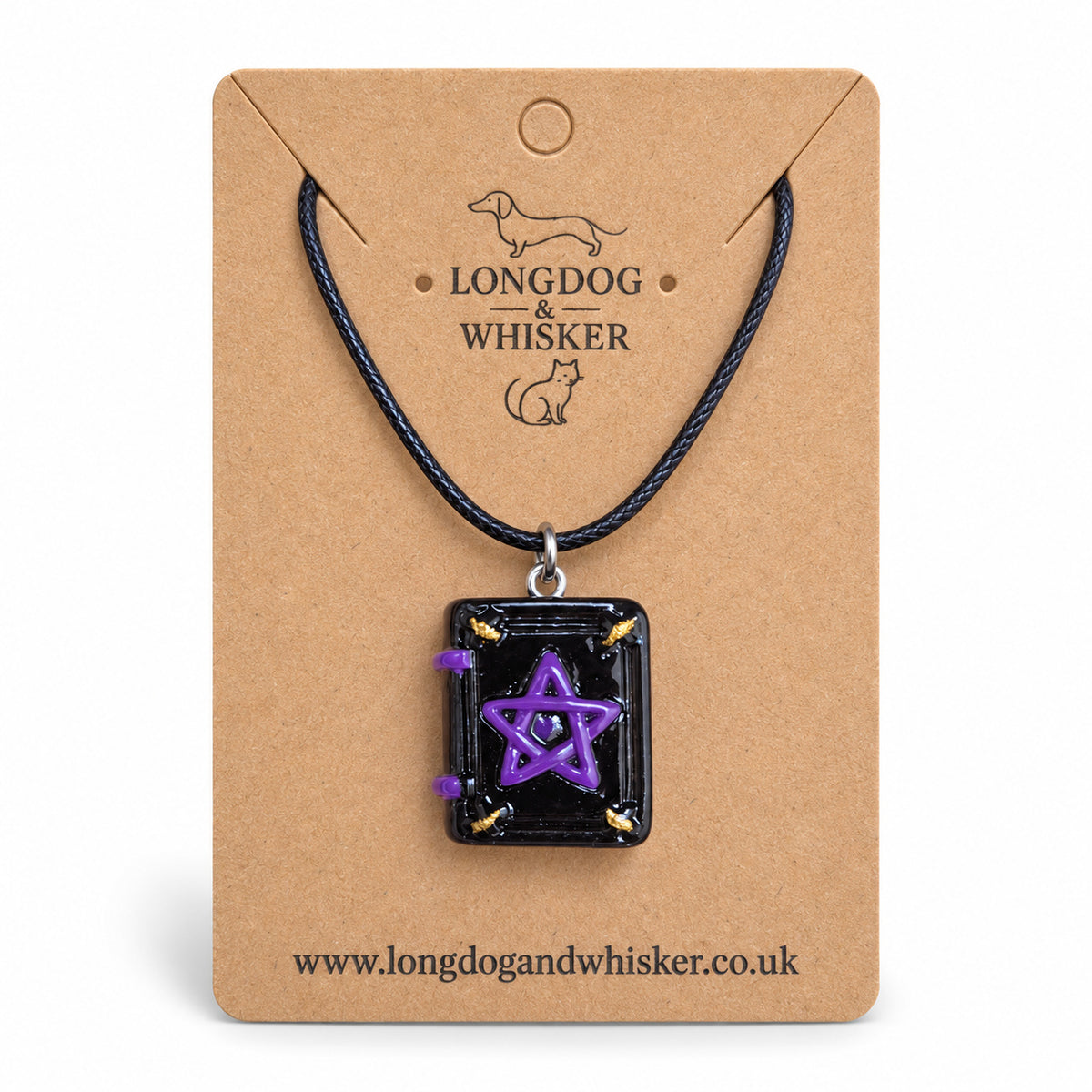 Black and purple spellbook necklace on black cord on a Longdog & Whisker kraft card against white