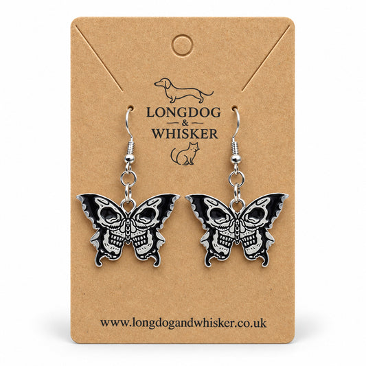 Black and silver double skull butterfly earrings on Longdog & Whisker kraft card