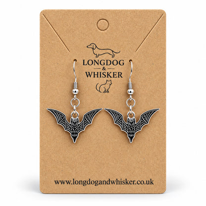 Black and silver skeletal bat drop earrings on Longdog & Whisker kraft card
