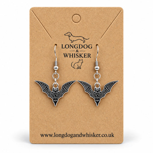 Black and silver skeletal bat drop earrings on Longdog & Whisker kraft card