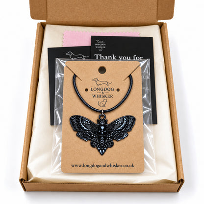 Black skull moth black-cord necklace in Longdog & Whisker postal packaging