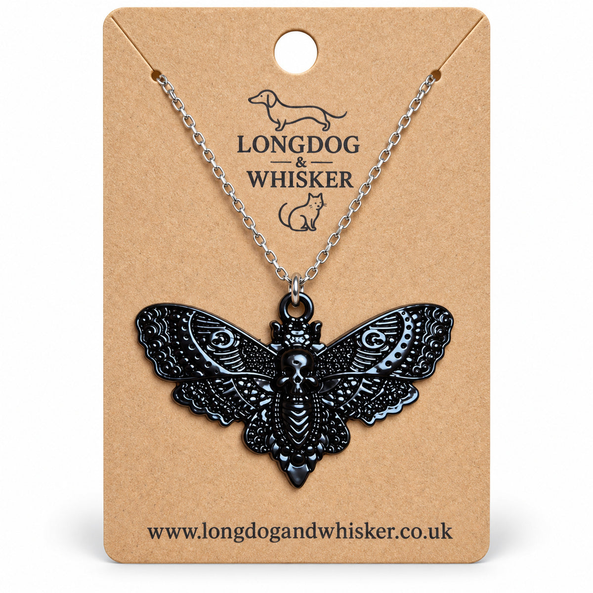 Black skull moth necklace on a silver chain, displayed on a Longdog & Whisker kraft card