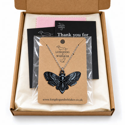Black skull moth silver-chain necklace in Longdog & Whisker postal packaging