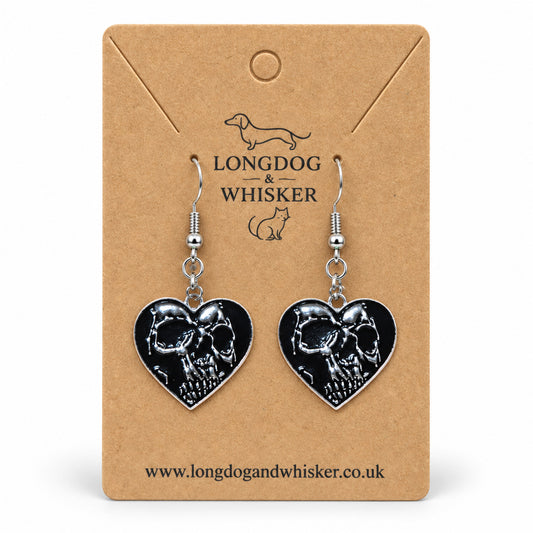 Black skull-shaped heart drop earrings on a Longdog & Whisker kraft product card