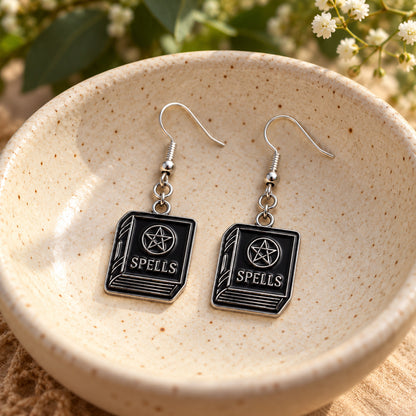 Black spellbook drop earrings in ceramic bowl lifestyle scene