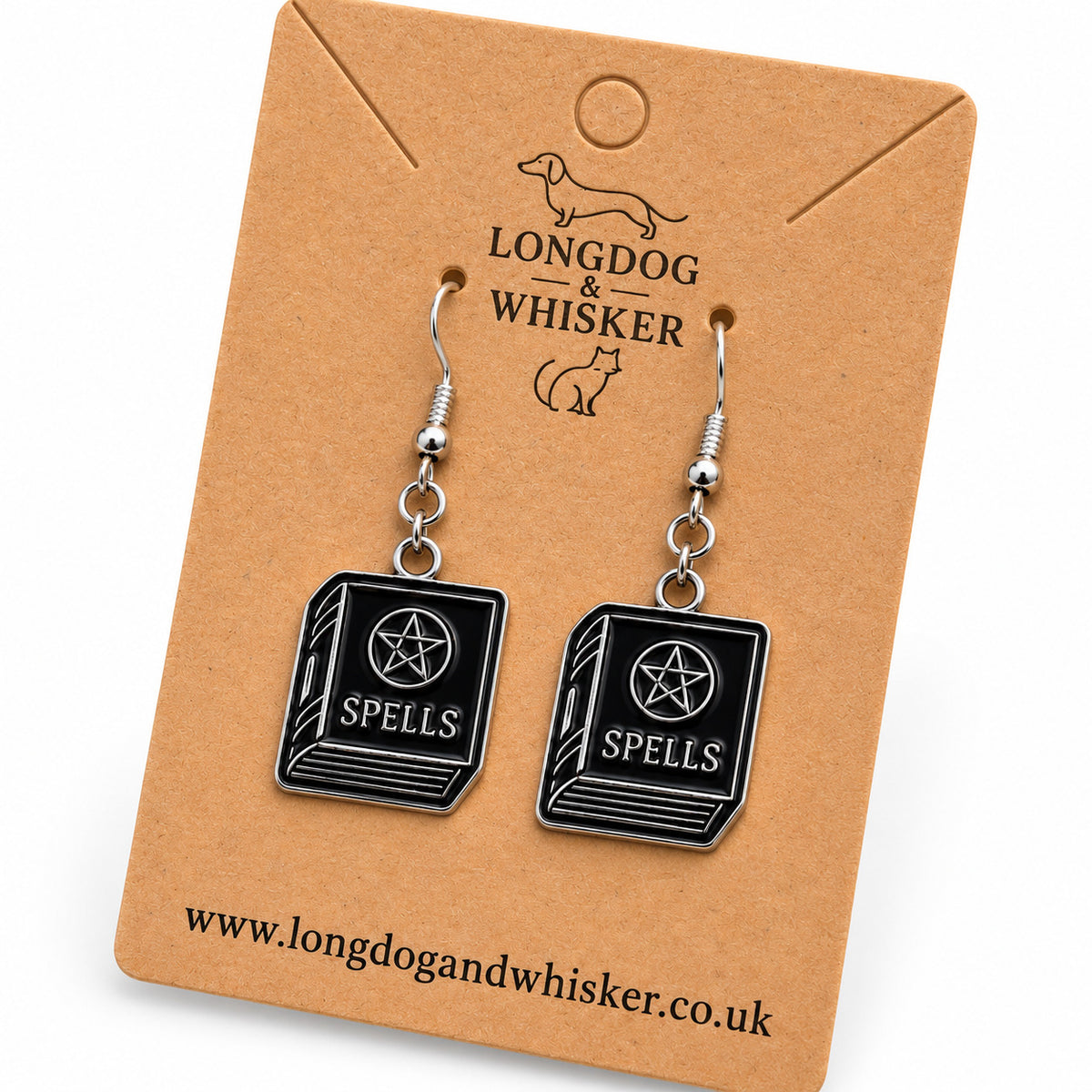 Close-up of black spellbook drop earrings