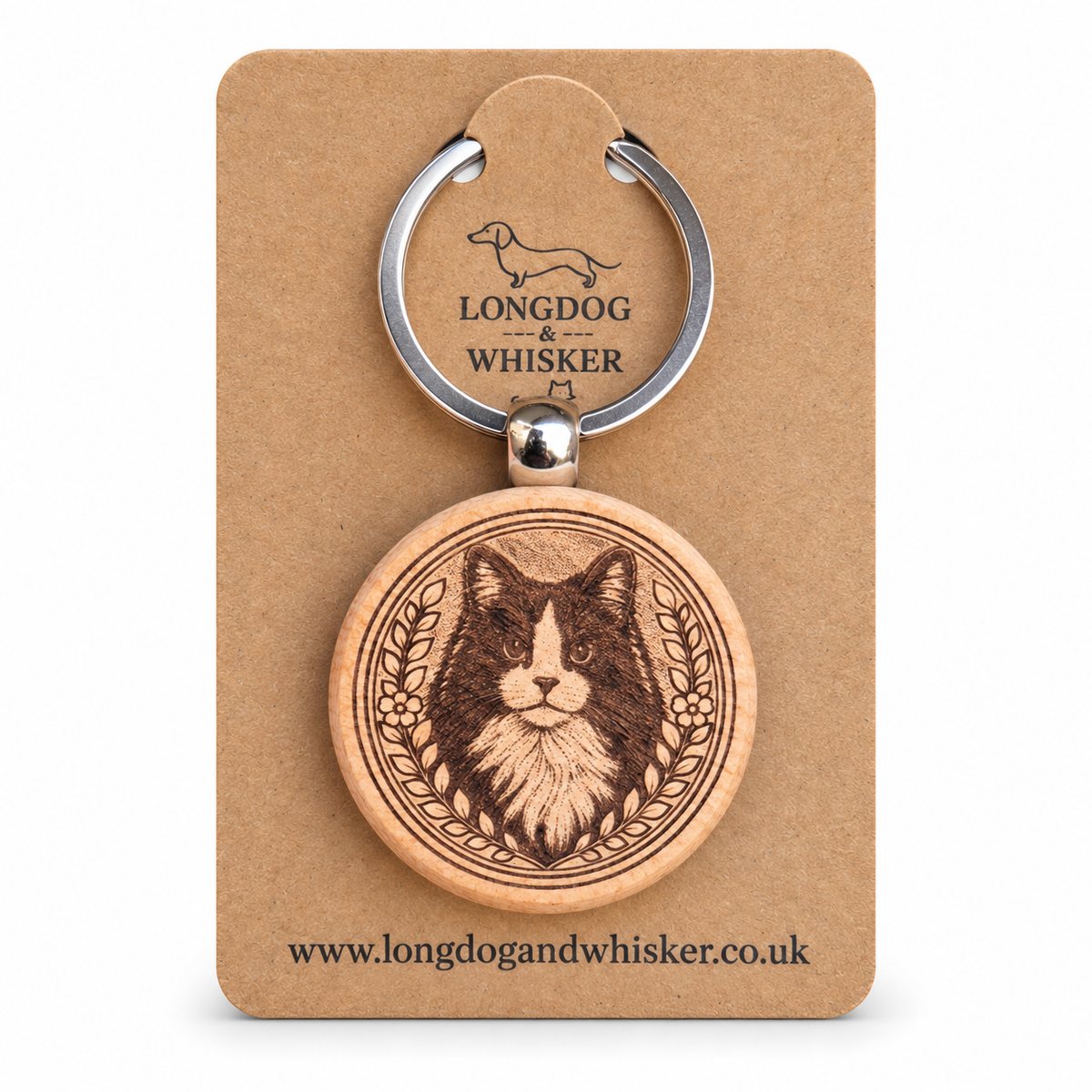 Black and white long-haired cat wooden keyring on its Longdog & Whisker kraft card