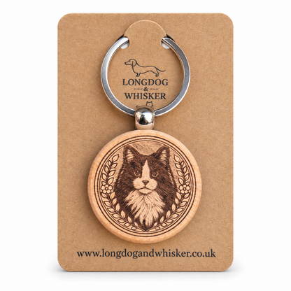 Black and white long-haired cat wooden keyring on its Longdog & Whisker kraft card