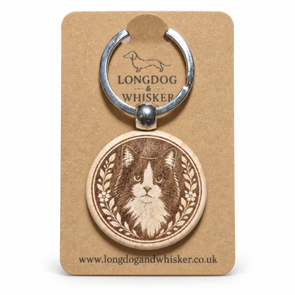 Black and white long-haired cat wooden keyring on its Longdog & Whisker card