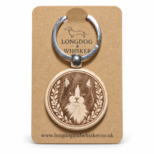 Black and white long-haired cat wooden keyring on its Longdog & Whisker card