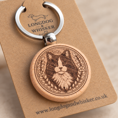 Close-up of the black and white long-haired cat engraving, wooden edge and silver connector