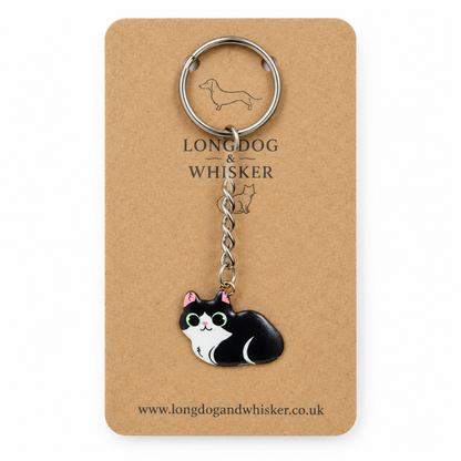 Close-up of black and white cat keyring and silver-tone hardware