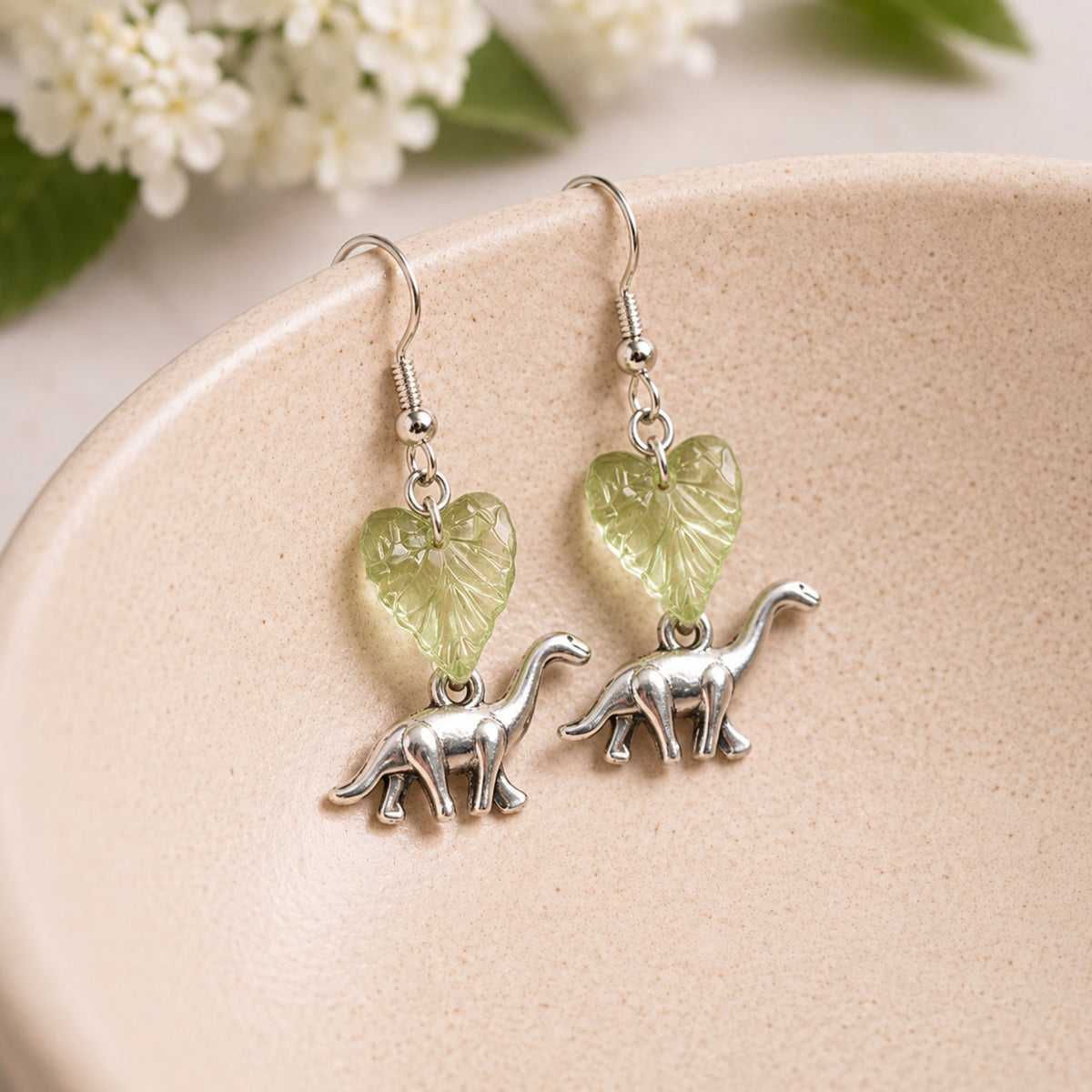Brontosaurus Earrings displayed in a lifestyle product photo