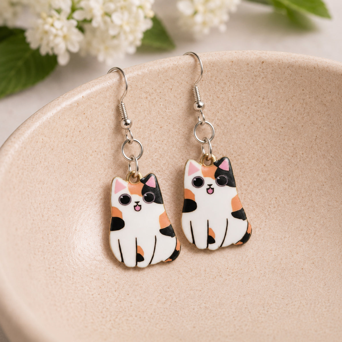 Chonky Cat Earrings - Calico displayed in a lifestyle product photo