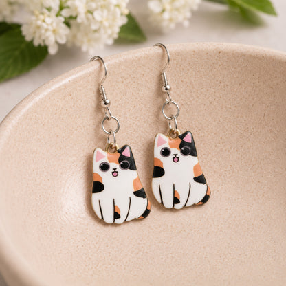 Chonky Cat Earrings - Calico displayed in a lifestyle product photo