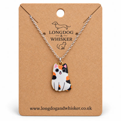 Calico chonky cat necklace on a silver chain, displayed on a Longdog & Whisker kraft card