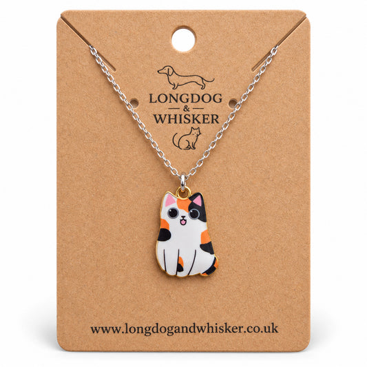 Calico chonky cat necklace on a silver chain, displayed on a Longdog & Whisker kraft card
