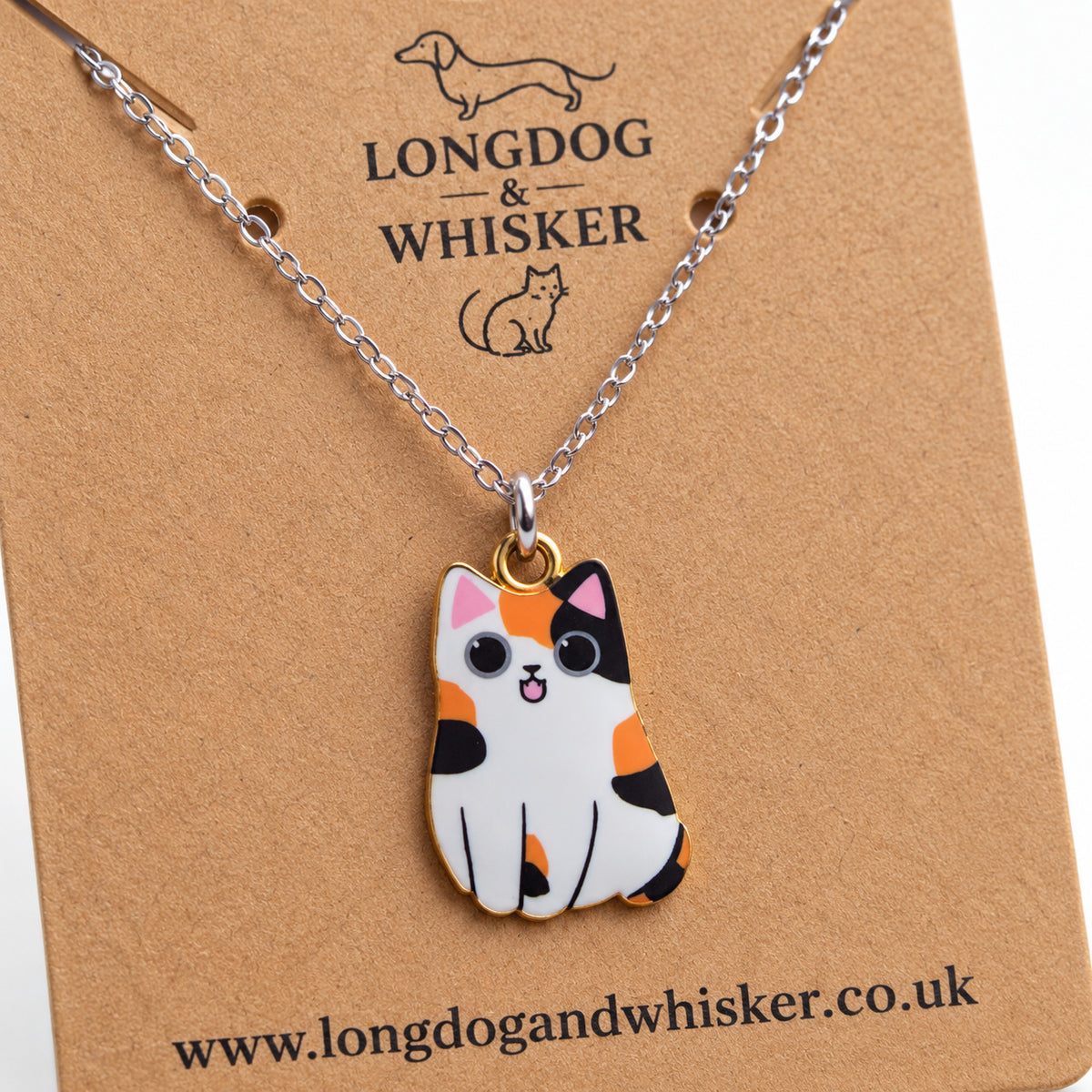Close-up of the Calico Chonky Cat Necklace showing its patchwork markings and gold-tone edging