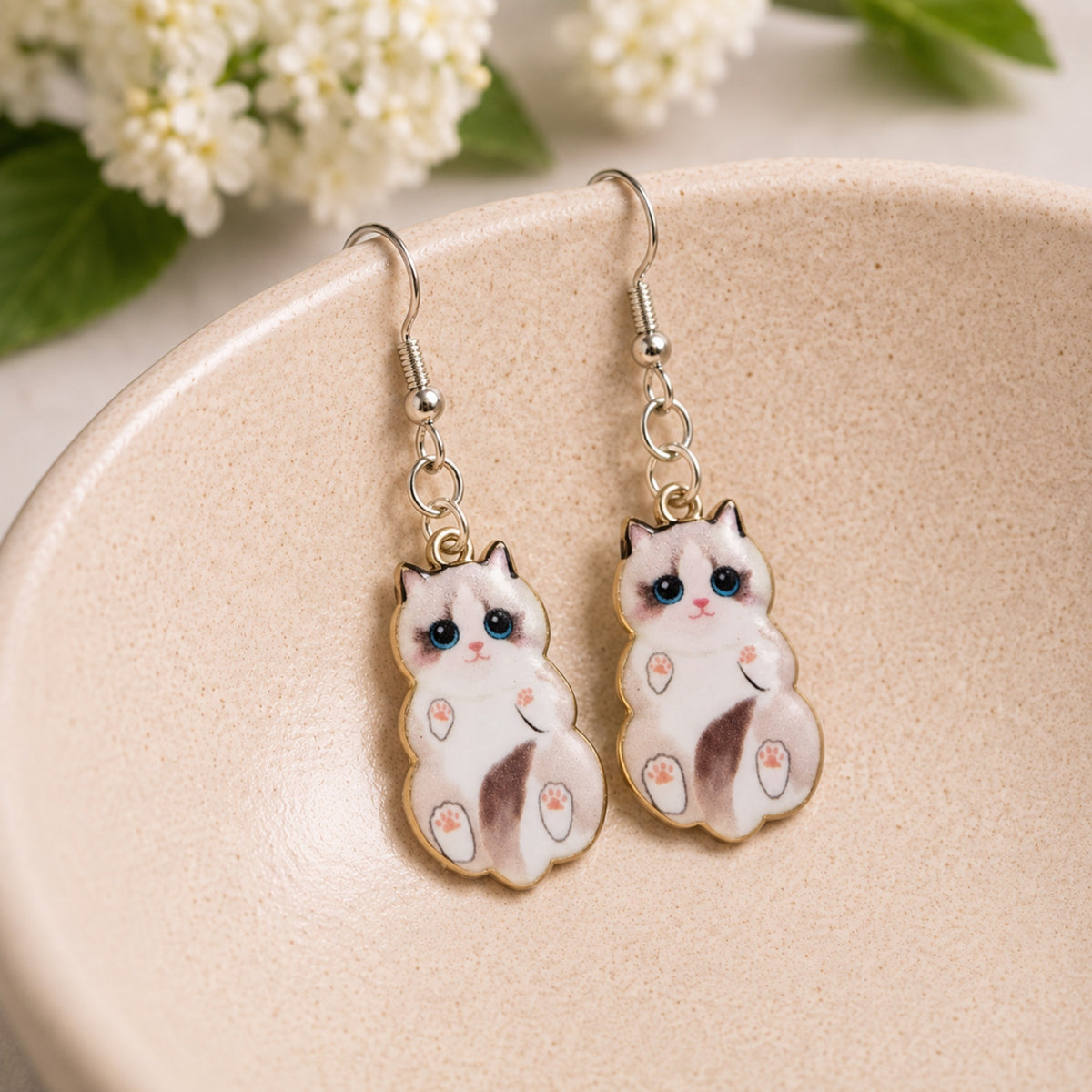 Belly Rub Cat Earrings - Ragdoll displayed in a lifestyle product photo