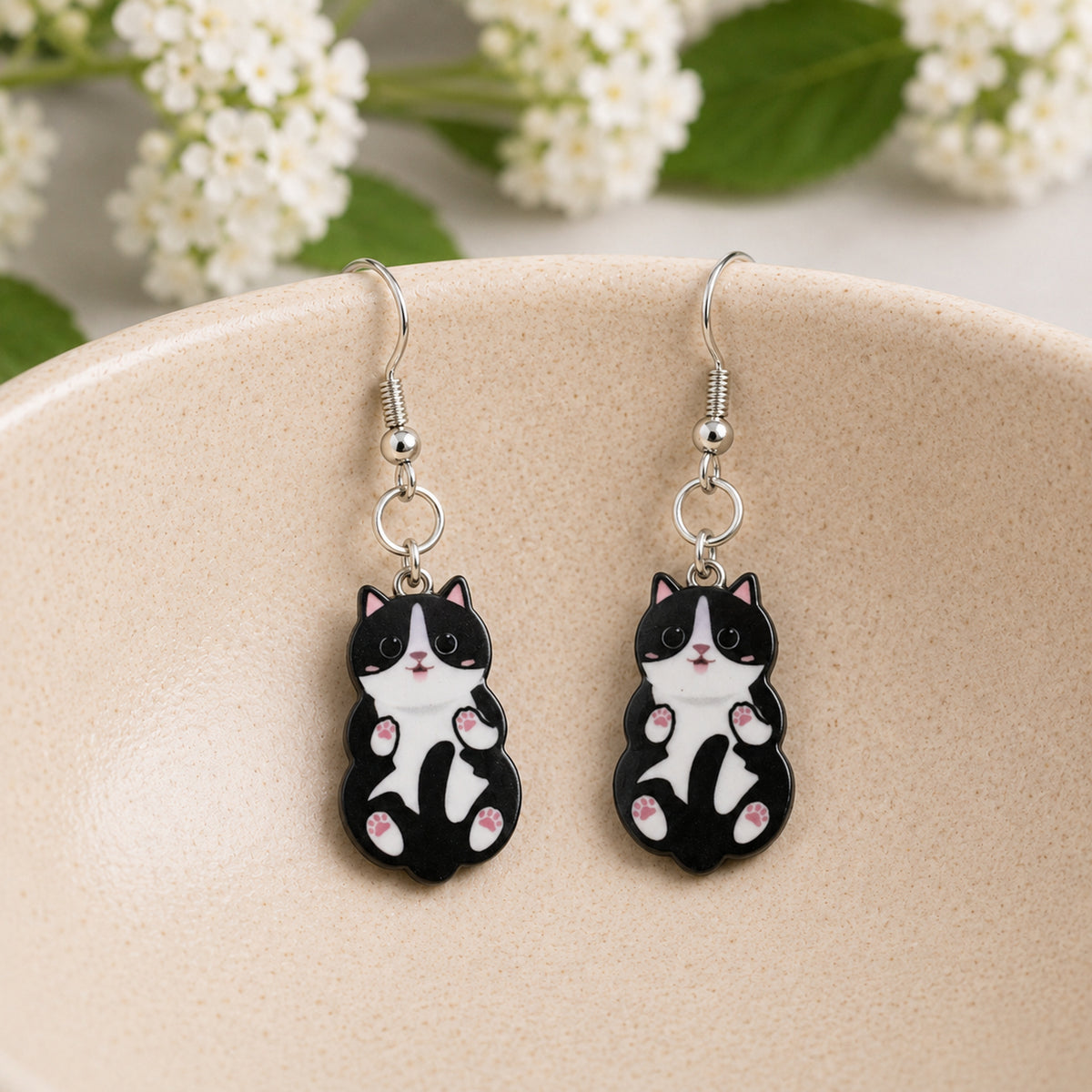 Belly Rub Cat Earrings - Black & White displayed in a lifestyle product photo