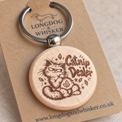 Close-up of the Catnip Dealer cat design on the wooden keyring