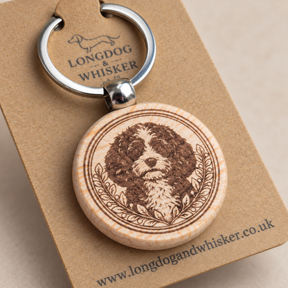 Close-up of Cavapoo portrait, leafy border, natural wood edge and silver connector