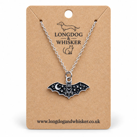 Celestial moon bat necklace on a silver chain, displayed on a Longdog & Whisker kraft card