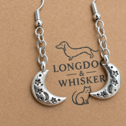 Close up of silver crescent moon earring details