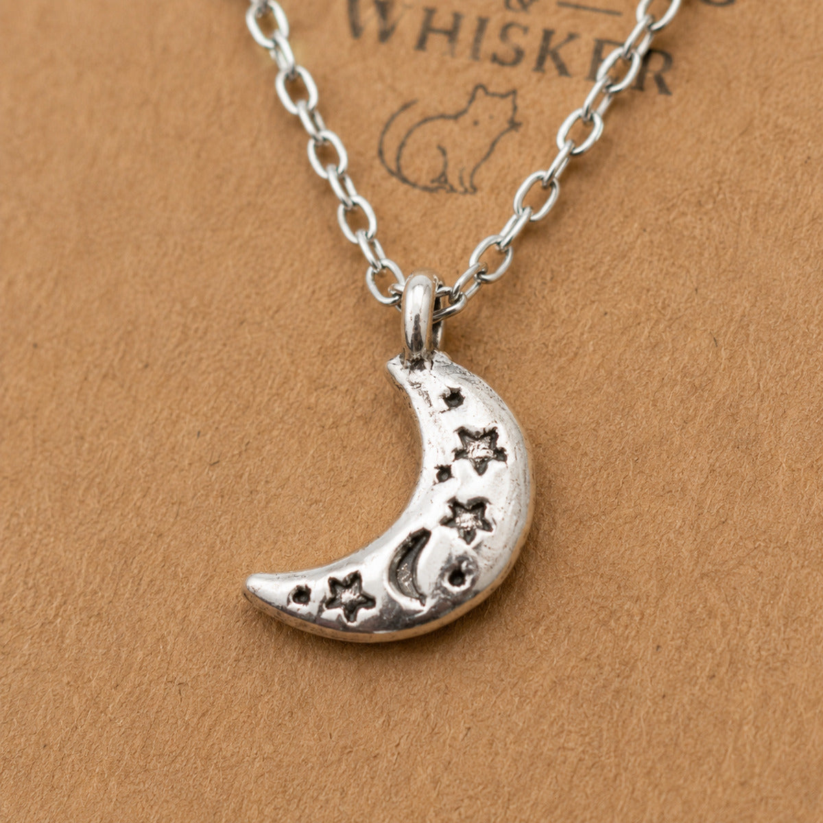 Close up of silver celestial moon necklace pendant