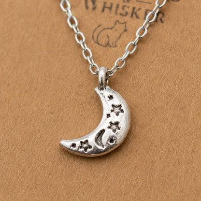 Close up of silver celestial moon necklace pendant