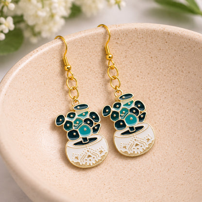 Coin Leaf Plant Pot Earrings displayed in a lifestyle product photo