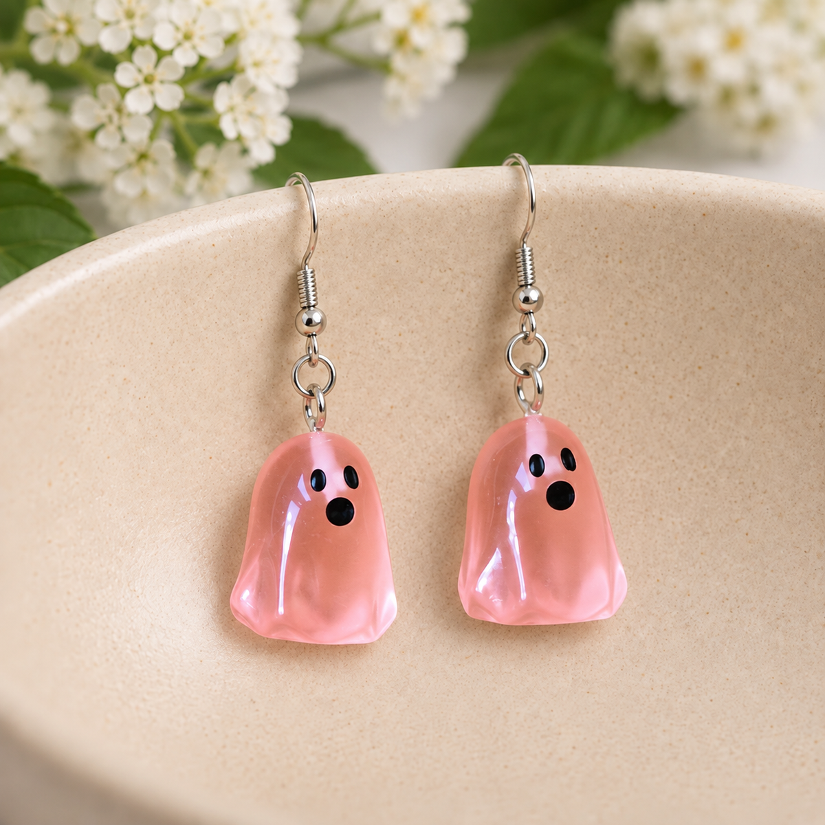 Coral Ghost Earrings arranged in a ceramic bowl