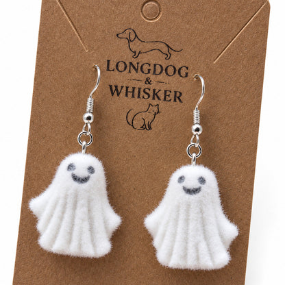 Close-up of Dancing Ghost Earrings showing their rounded fluffy felt finish and silver-tone hooks