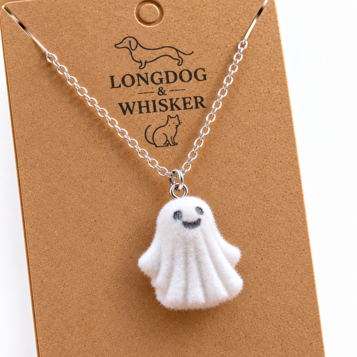 Close-up of Dancing Ghost Necklace pendant and chain on a Longdog & Whisker card
