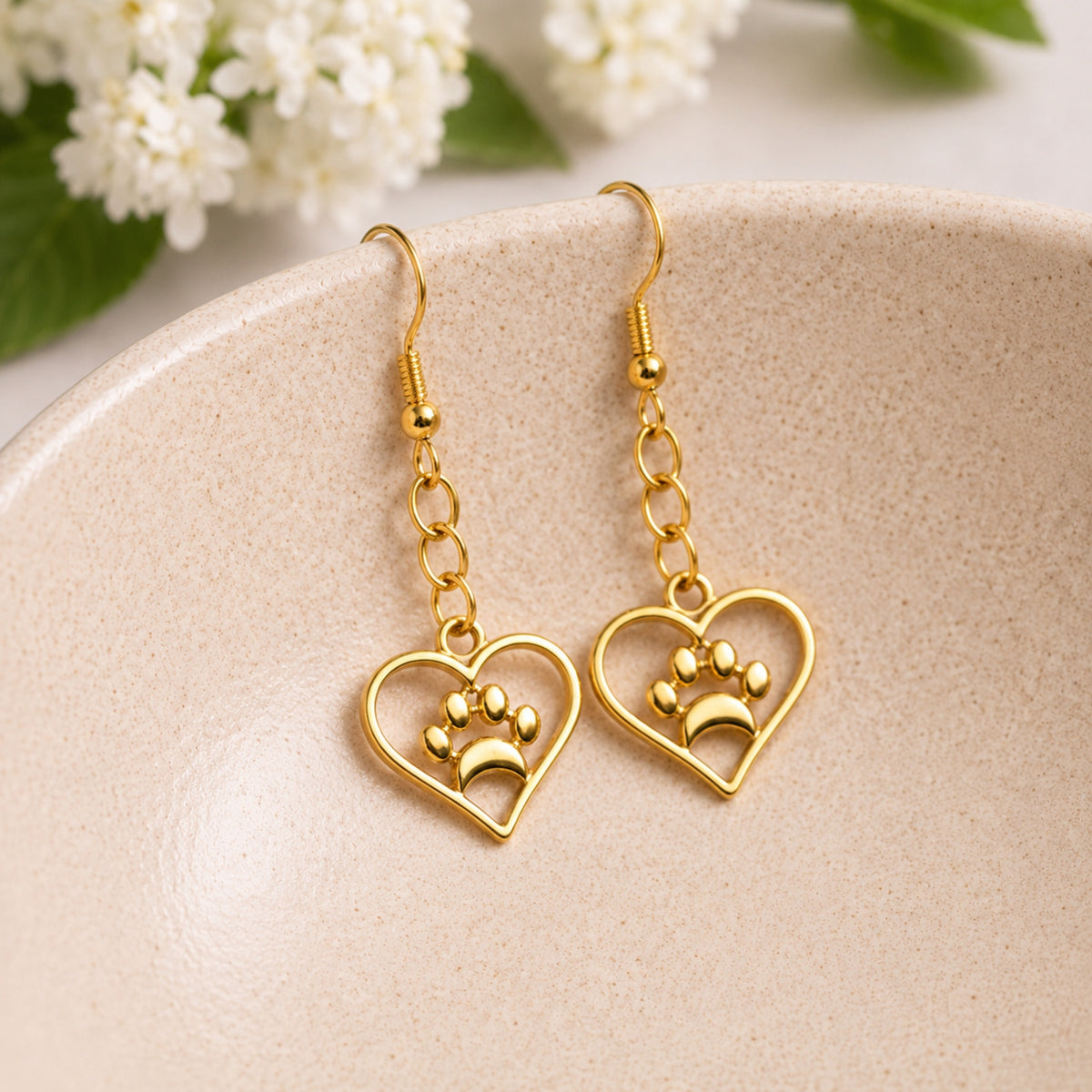 Gold Heart Dog Paw Print Earrings displayed in a lifestyle product photo