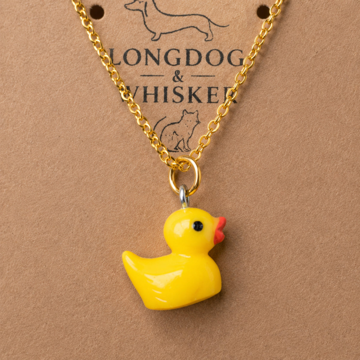 Close up of Rubber Duck Necklace pendant and gold chain