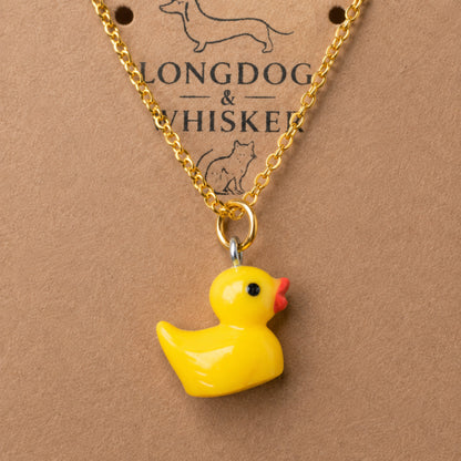 Close up of Rubber Duck Necklace pendant and gold chain