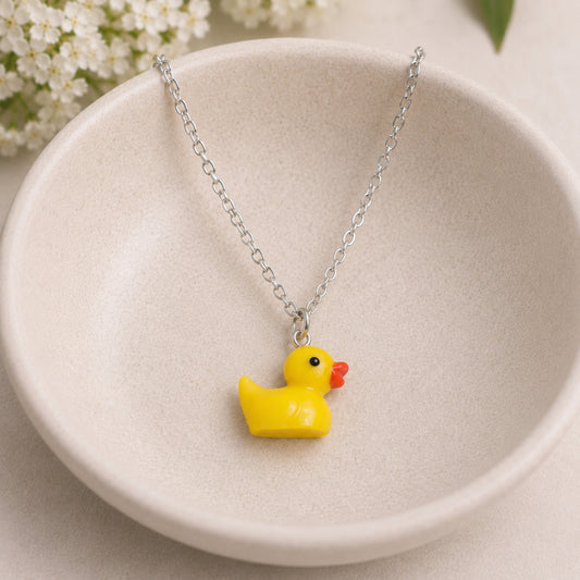 Rubber Duck Necklace with silver chain in bowl lifestyle scene