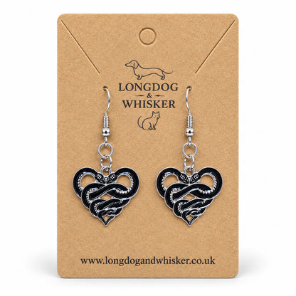 Entwined Snake Heart Drop Earrings displayed on a Longdog & Whisker card