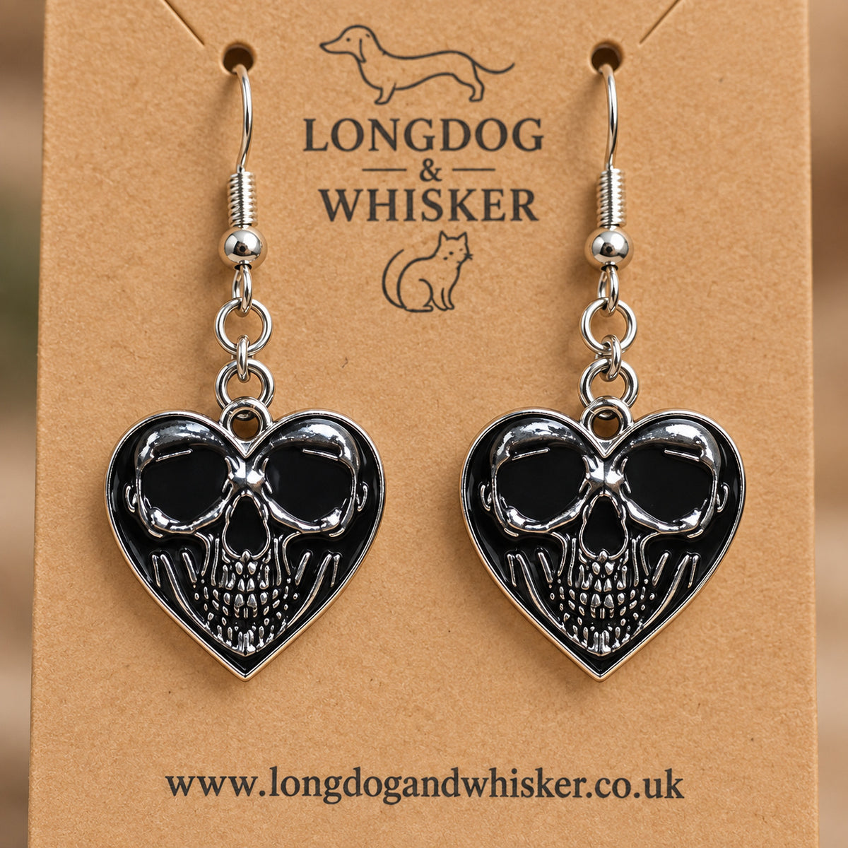 Close-up of the centred skull detail on black heart-shaped earrings