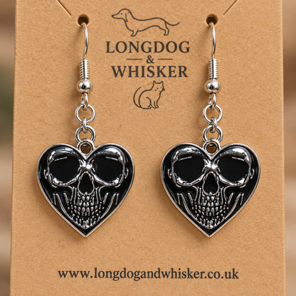 Close-up of the centred skull detail on black heart-shaped earrings