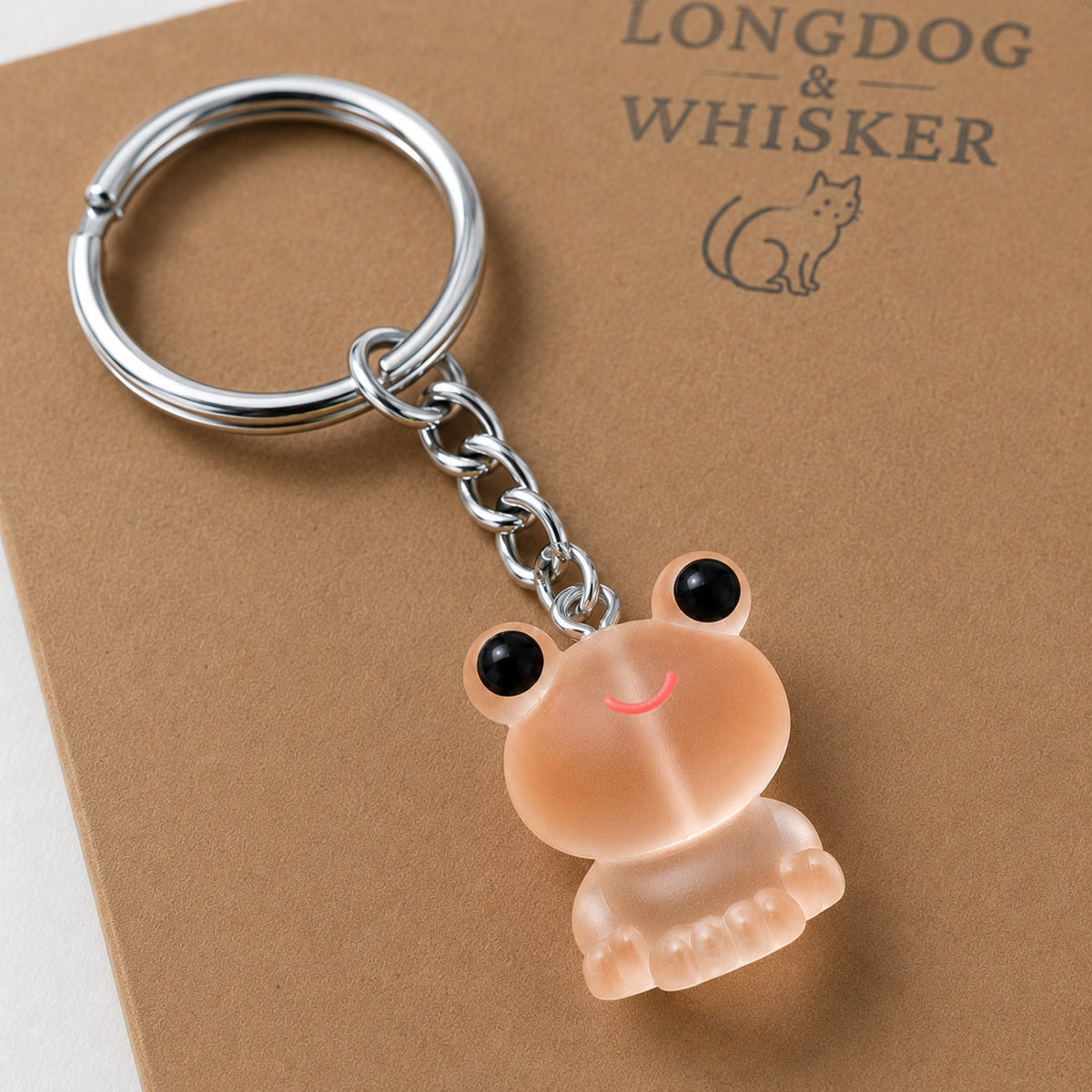 Close-up detail of the Frosted Frog in Apricot Keyring & Bag Charm