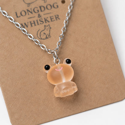 Close-up detail of Frosted Frog in Apricot Necklace