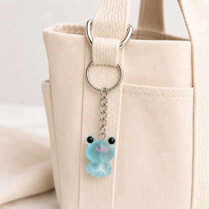 Frosted Frog in Aqua Keyring & Bag Charm attached to a cream canvas bag