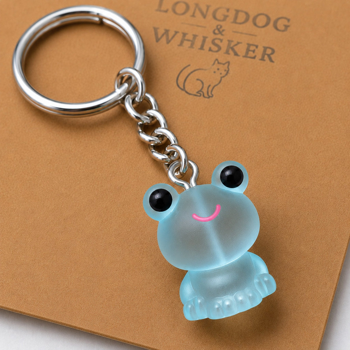 Close-up detail of the Frosted Frog in Aqua Keyring & Bag Charm