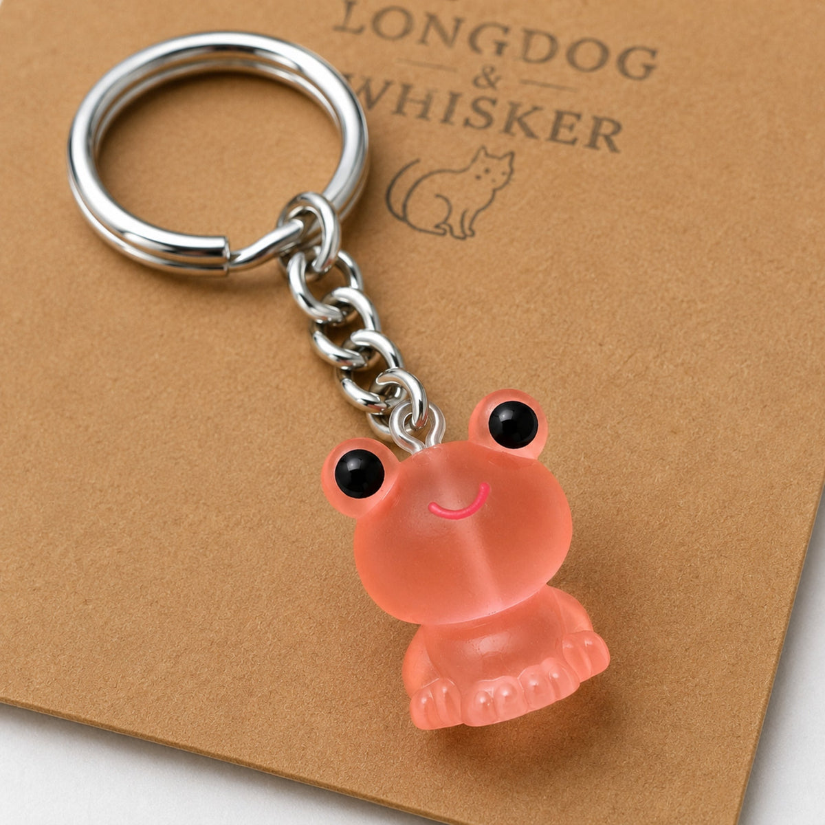 Close-up detail of the Frosted Frog in Coral Keyring & Bag Charm