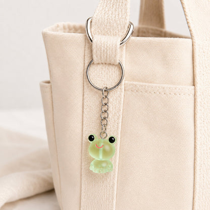 Frosted Frog in Green Keyring & Bag Charm attached to a cream canvas bag