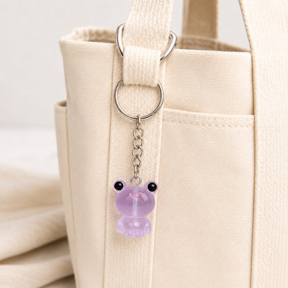 Frosted Frog in Lilac Keyring & Bag Charm attached to a cream canvas bag