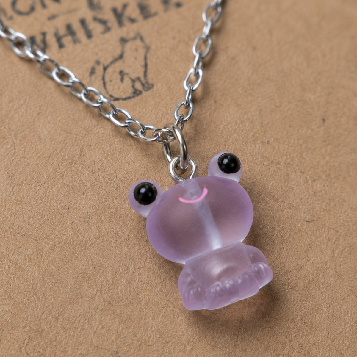 Close-up detail of Frosted Frog in Lilac Necklace