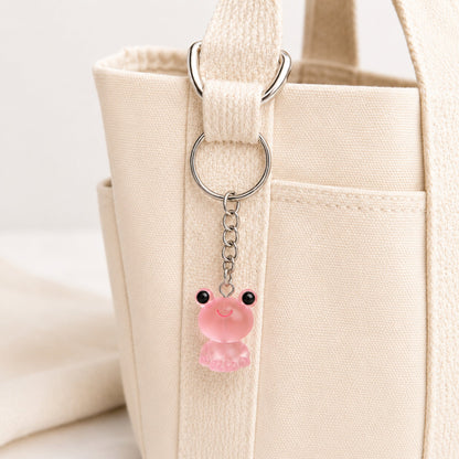 Frosted Frog in Pink Keyring & Bag Charm attached to a cream canvas bag